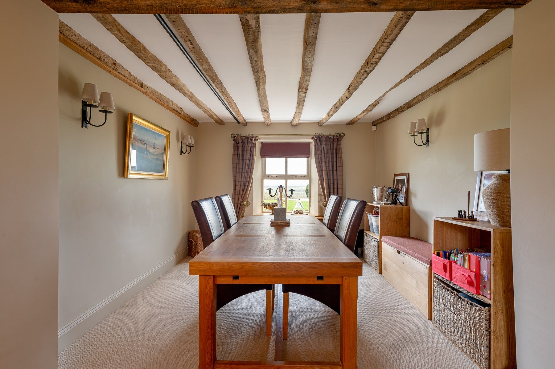 Beamed dining room with long oak table
