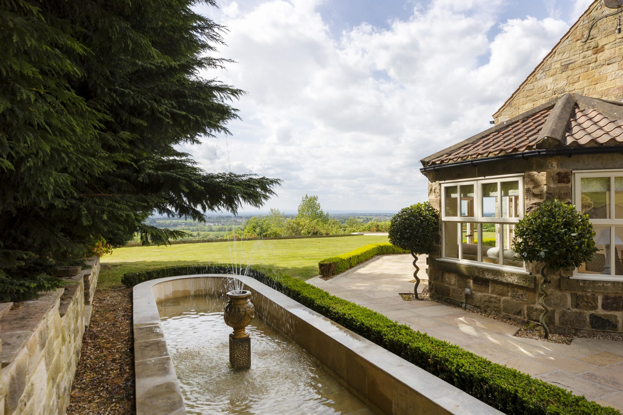 The rill water feature running along the garden wall
