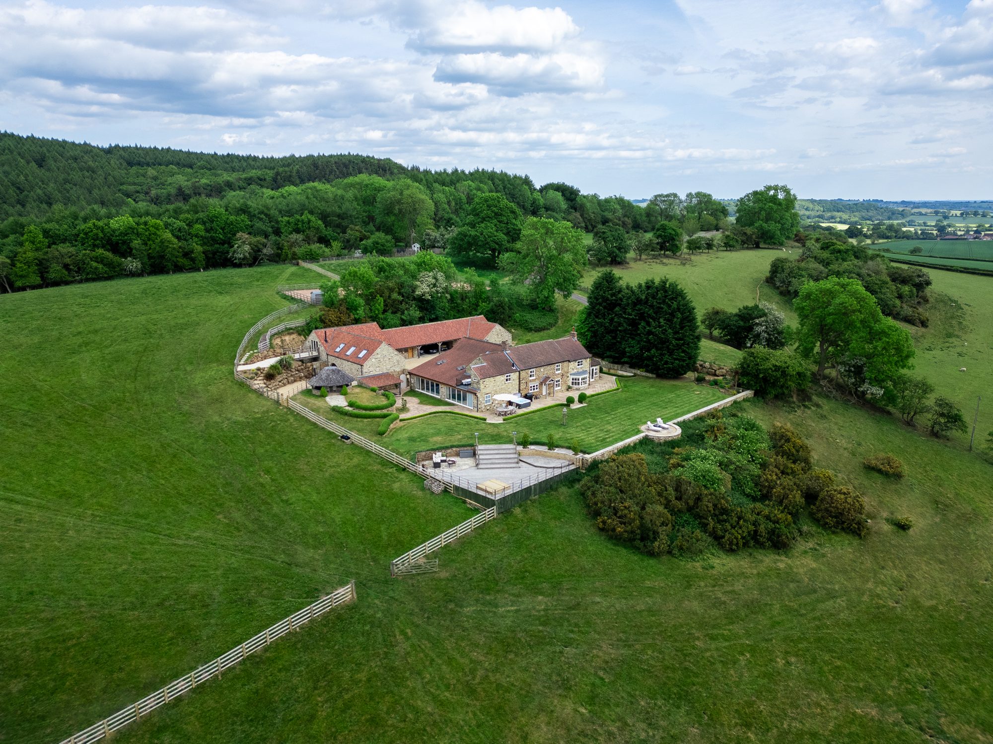 Wide aerial view of the house in its own grounds
