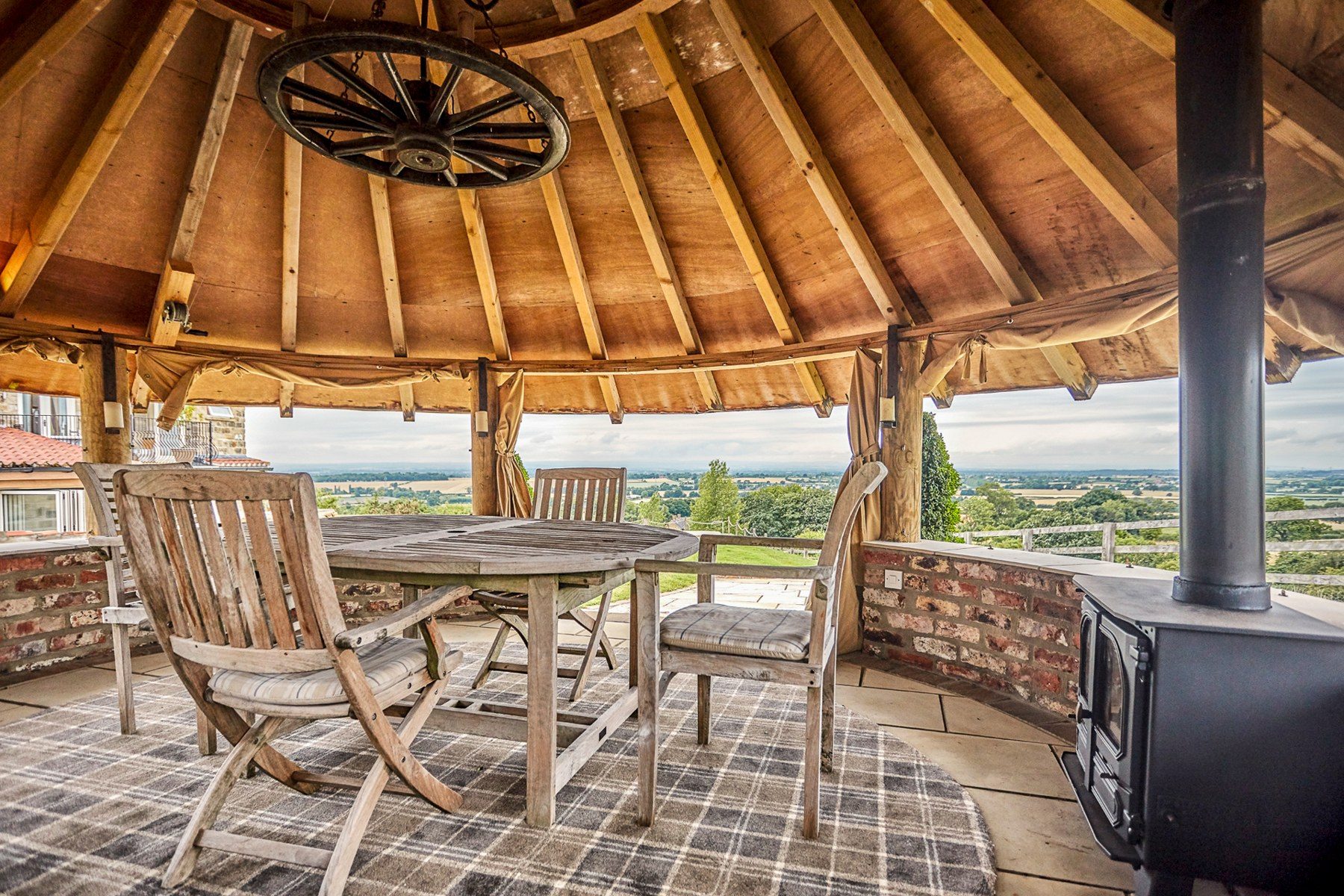 Round stone summer house with wood burner and dining table