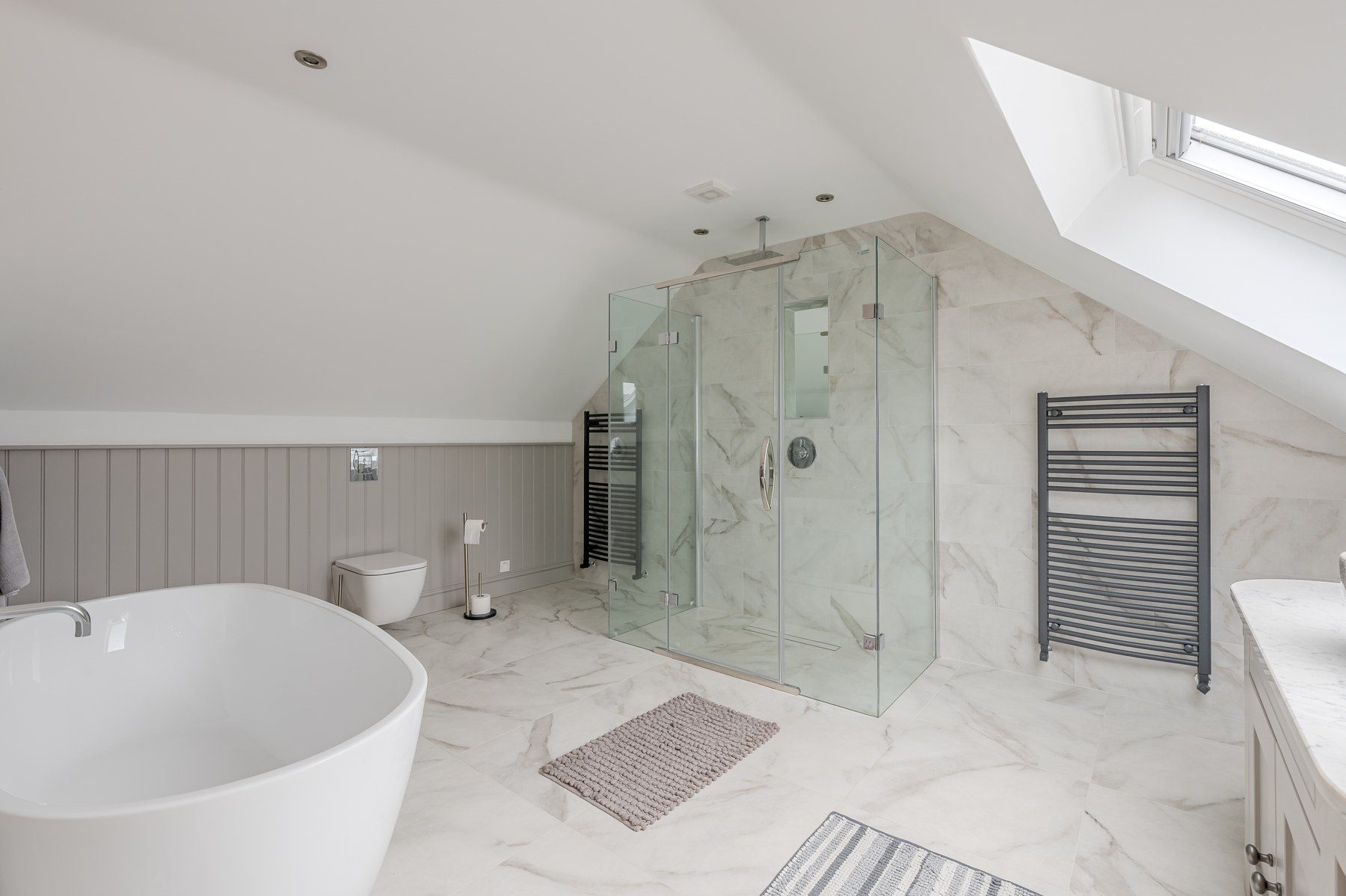 Marble bathroom with freestanding tub and glass shower