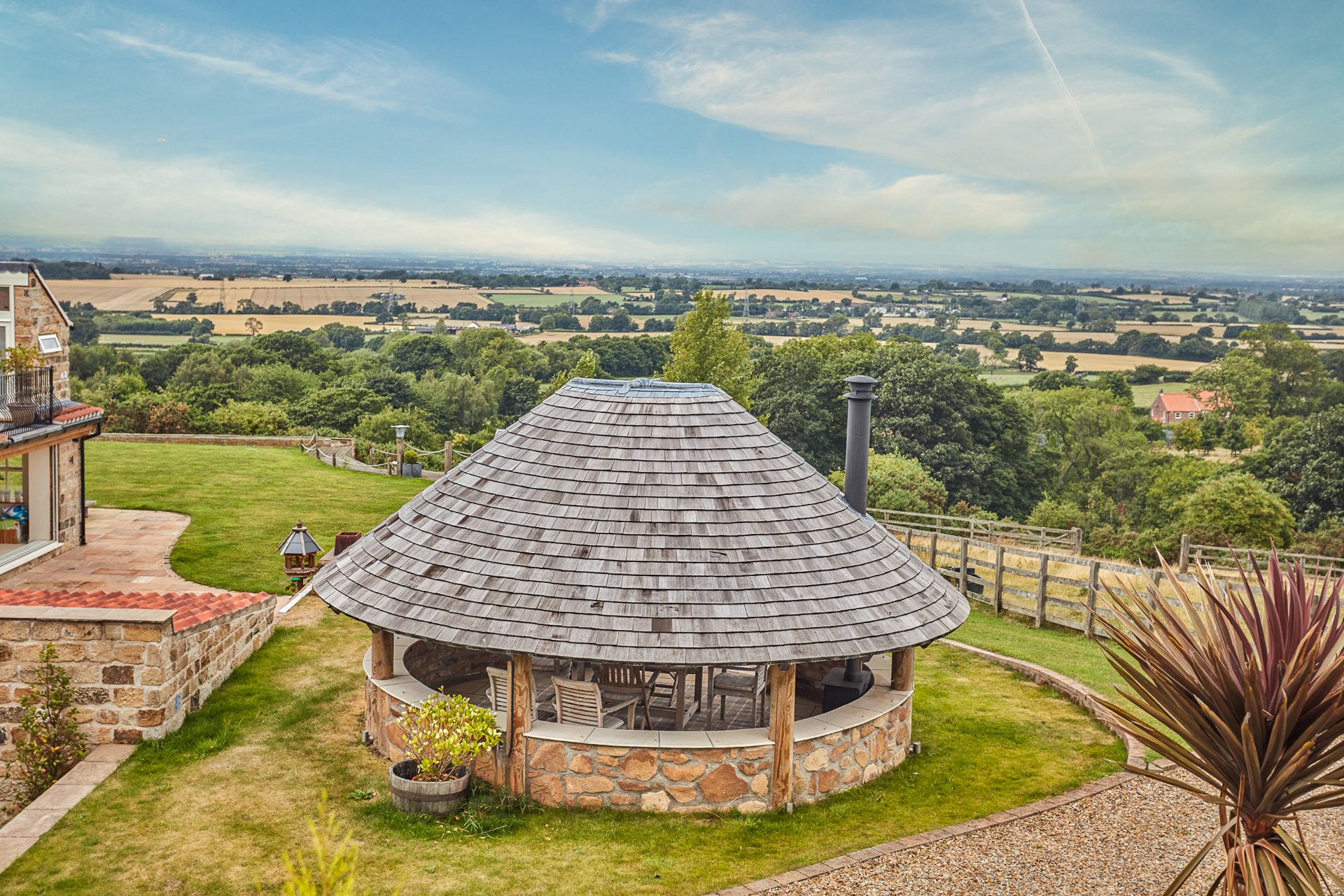 The round summer house from above with the valley behind