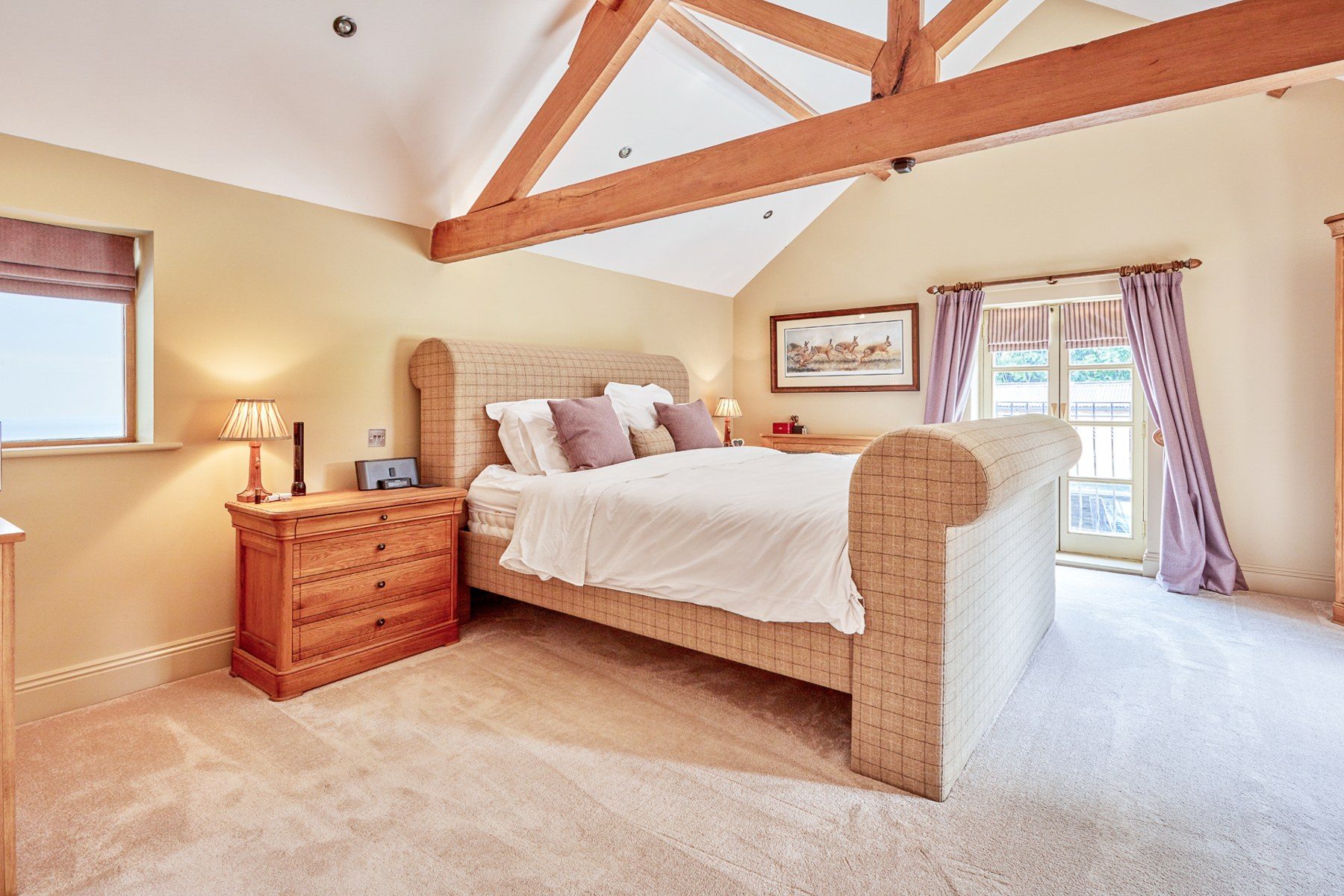 Bedroom 4 under the eaves with a checked upholstered bed