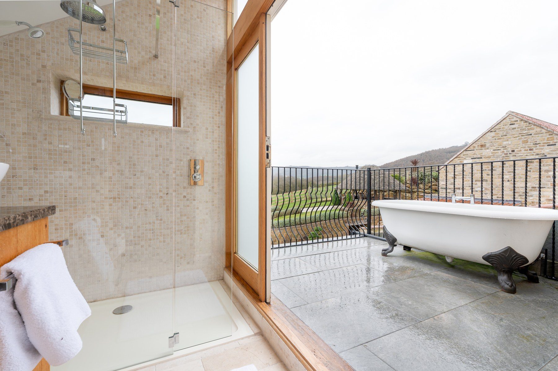 Roll-top bath on the private balcony beside the shower room