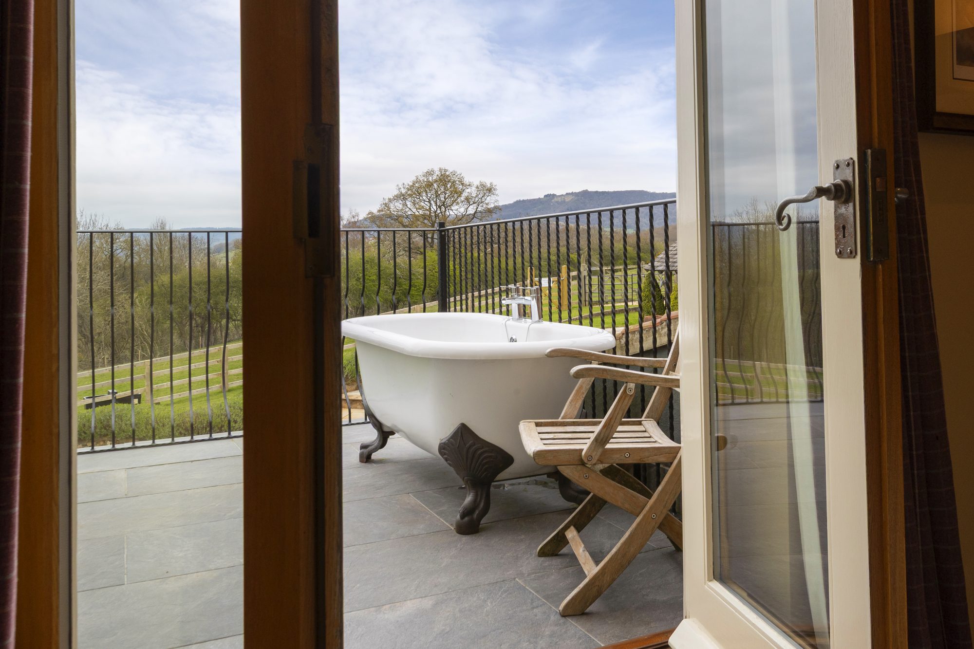 The balcony bath seen through the shower room doors
