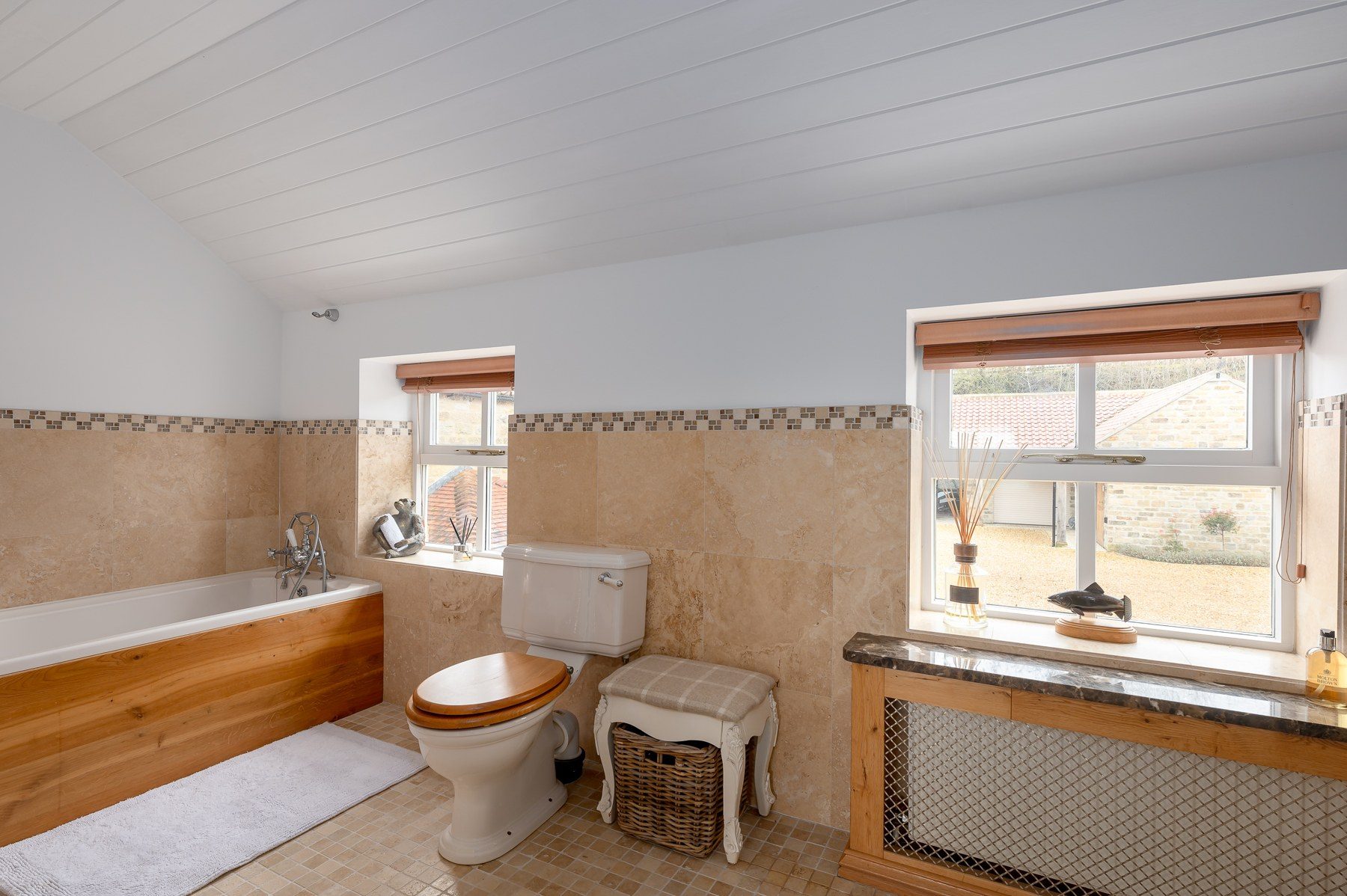 Family bathroom with panelled bath and view