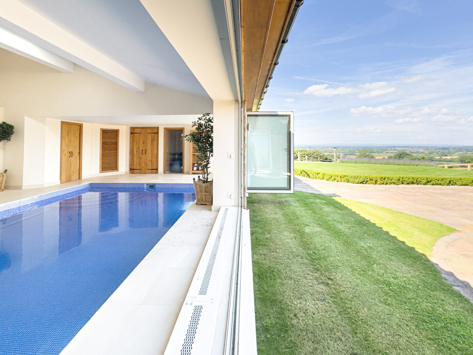 Pool edge with lawn and open countryside beyond
