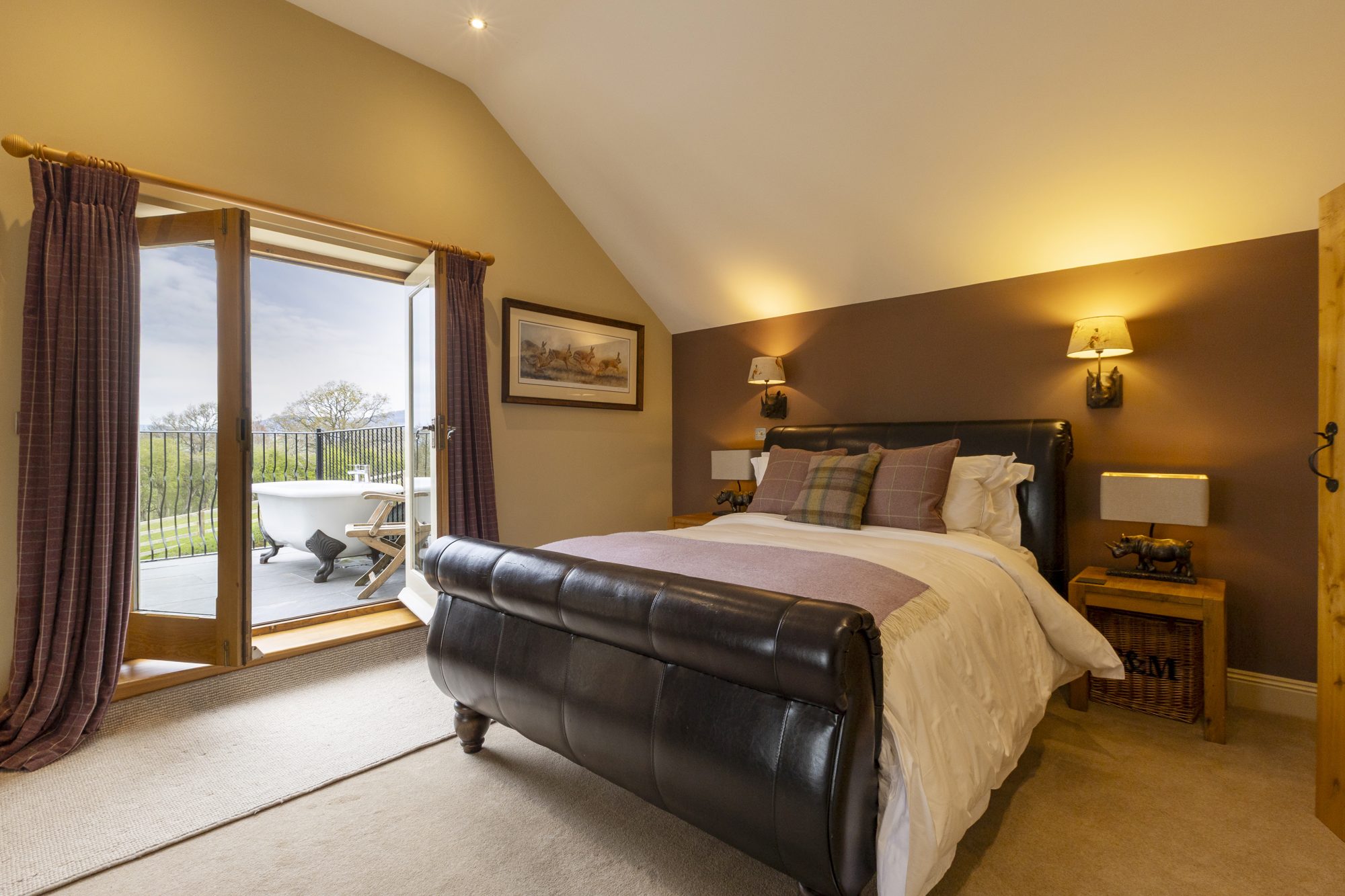 Bedroom 2 with the balcony doors open to the bath and views