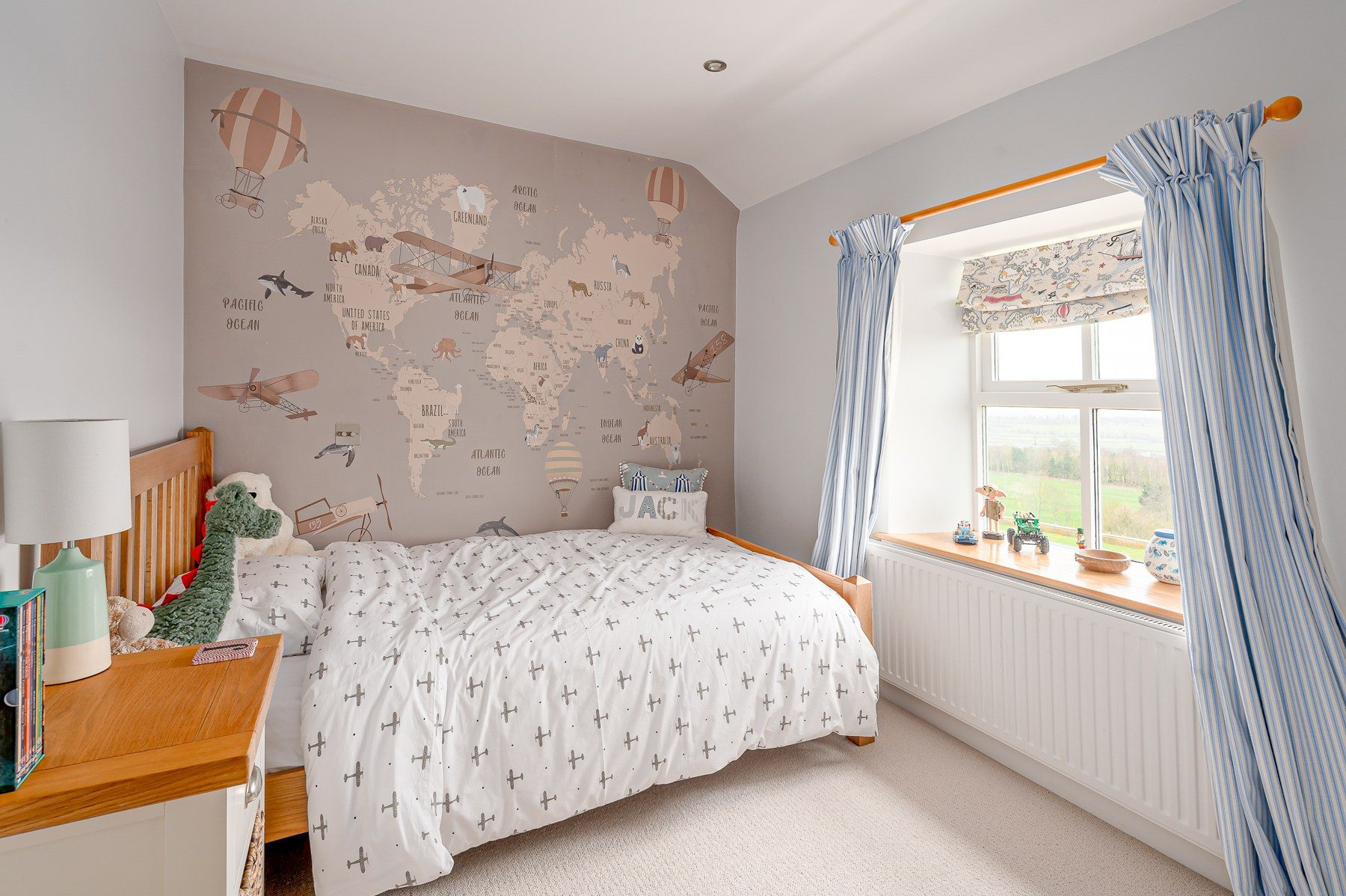 Children's bedroom with map wall and single bed
