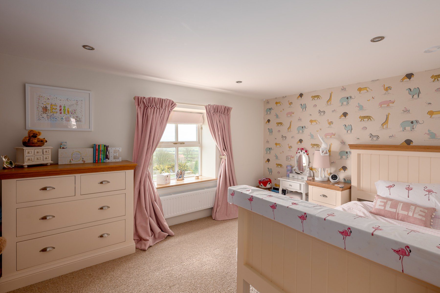Children's bedroom with animal wallpaper and painted chest of drawers