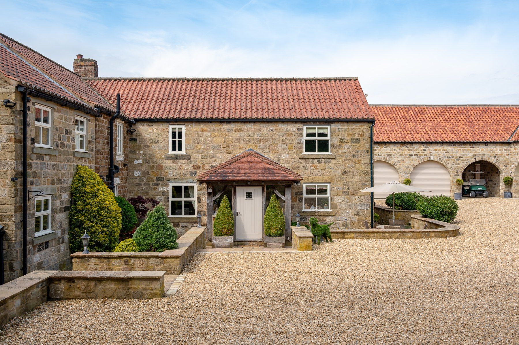 Stone front elevation of Osgoodby Cottage with pillared porch