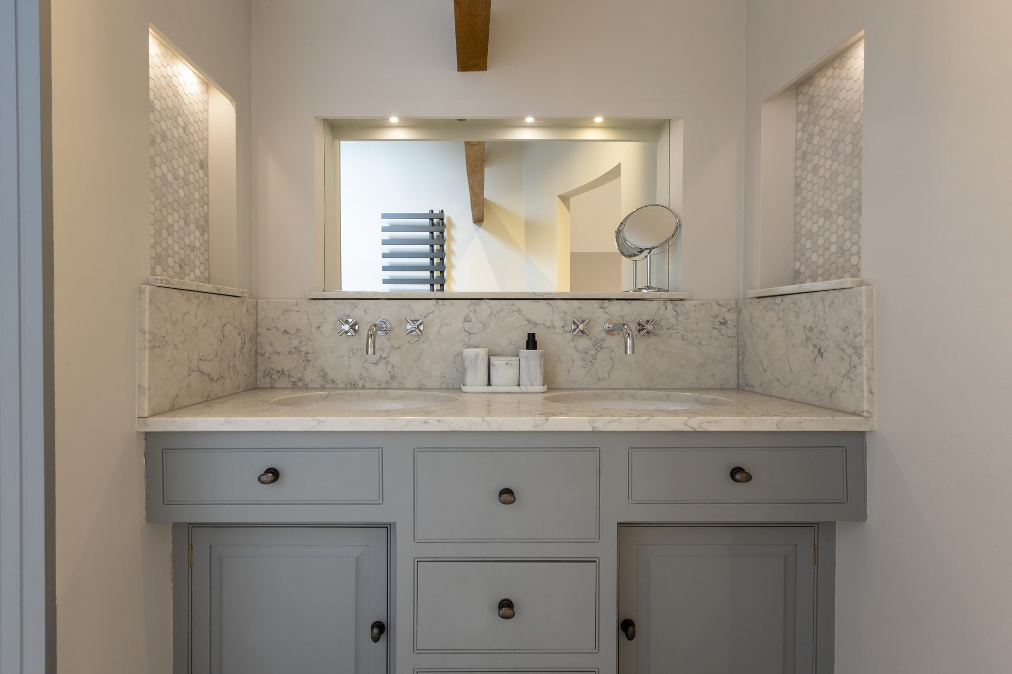 Marble vanity and mirror in the vaulted en-suite