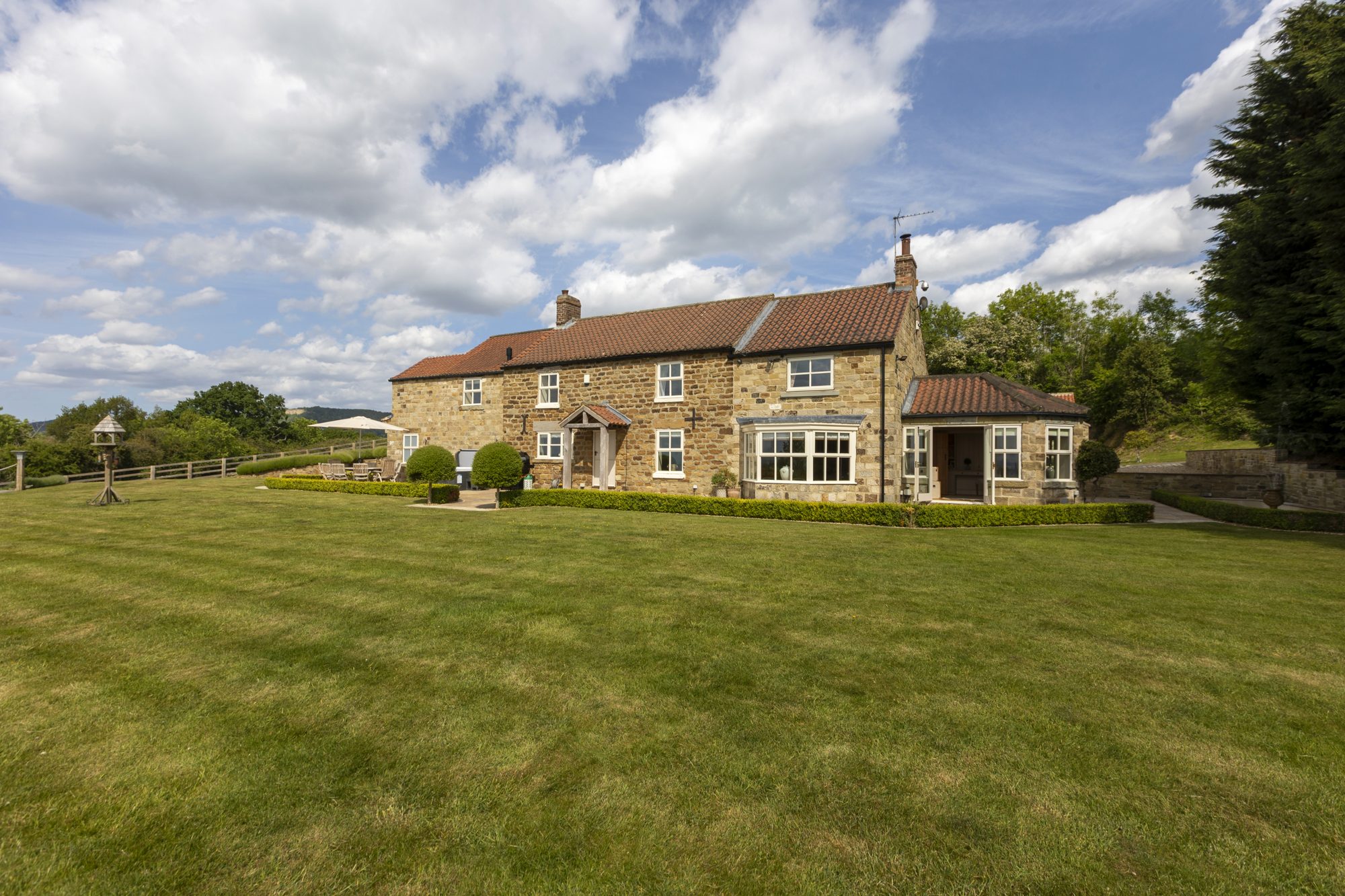 The house seen across the wide lawn