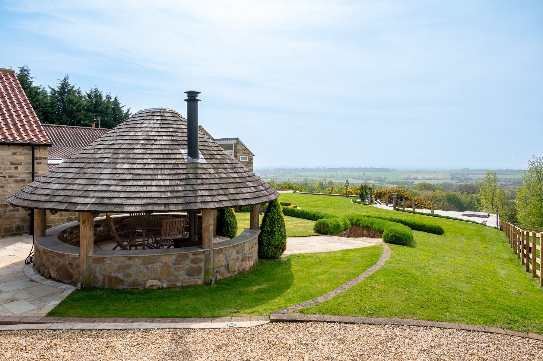 Shingle-roofed summer house in the garden