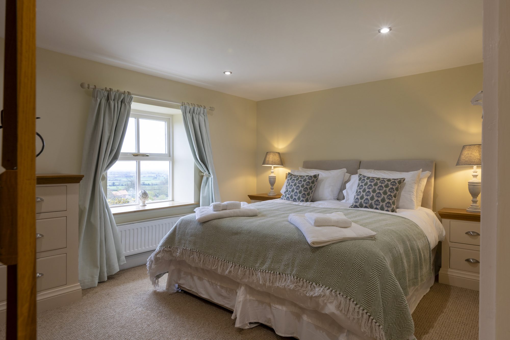 Bedroom 5 dressed with a soft grey throw