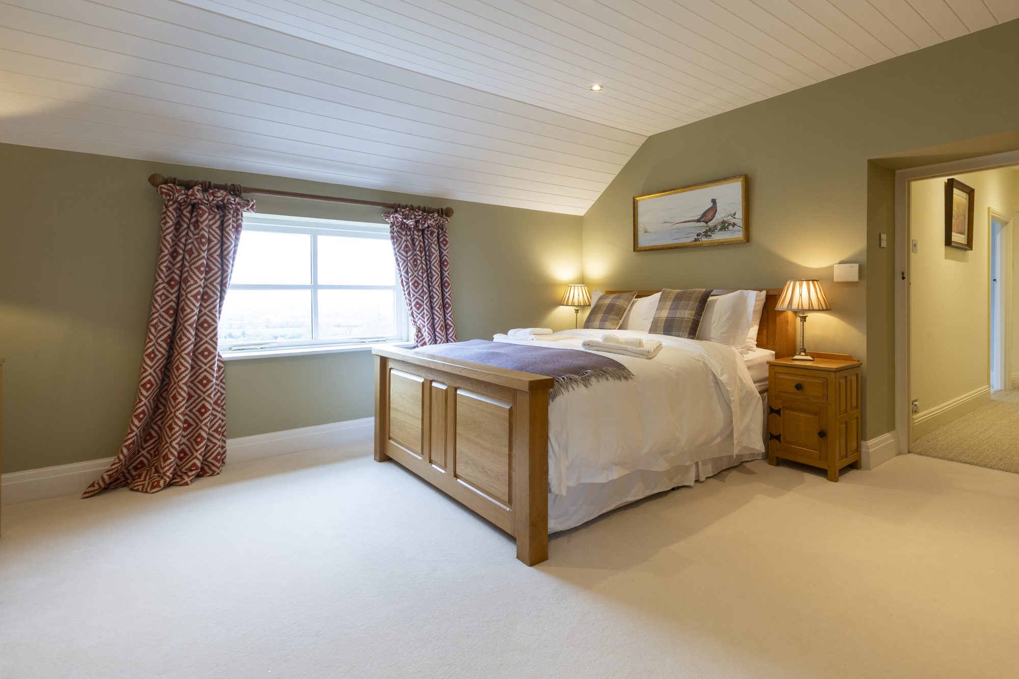 Bedroom 3 with sage walls and oak furniture